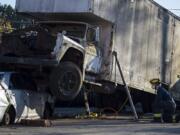 Firefighter Cory Anderson, right, joins colleagues during a simulated accident using their new heavy extrication equipment, which is capable of stabilizing up to 20,000 pounds and actively lifting 10 tons, at Vancouver Fire Department headquarters.