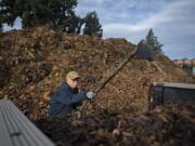 Doug Parker of Vancouver drops off a batch of leaves at H&H Wood Recyclers while participating in the leaf voucher program on Monday. Vancouver and Clark County are offering a free leaf disposal coupon program in an attempt to keep leaves from clogging storm drains.