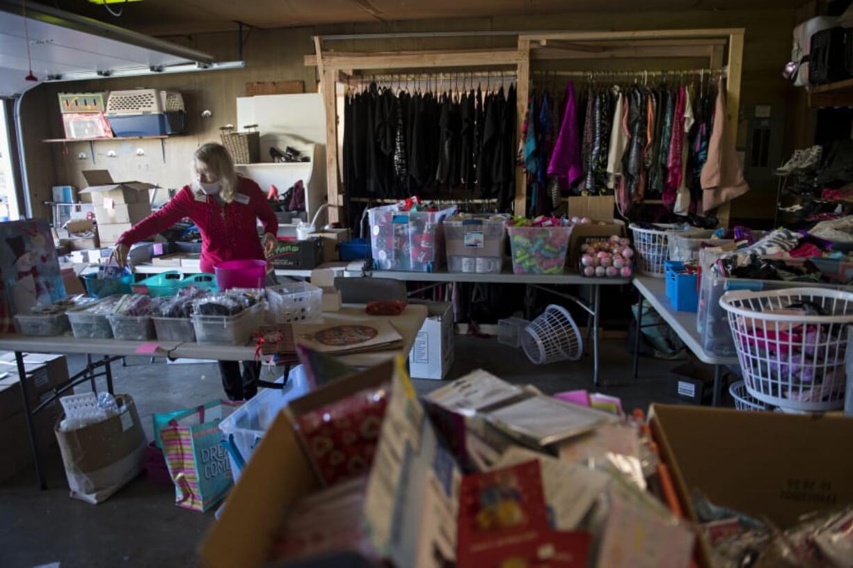 Debbie Russell, treasurer and co-founder of nonprofit group Loving Them Forward, helps make gift baskets to be given out to caregivers in Clark County.