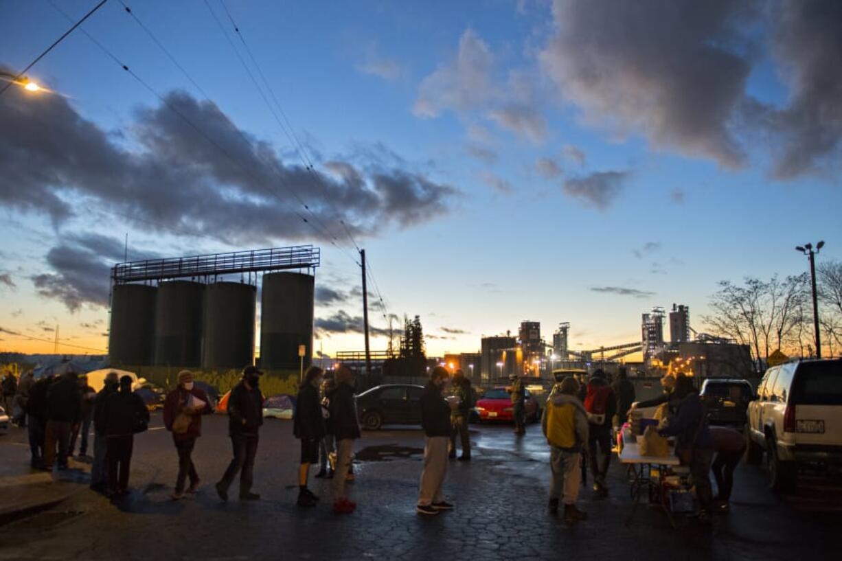 A line of people in need stretches out near Share House as Free Hot Soup Vancouver gives away meals in downtown Vancouver. Free Hot Soup Vancouver volunteers say the pandemic has negatively impacted homelessness in Clark County.