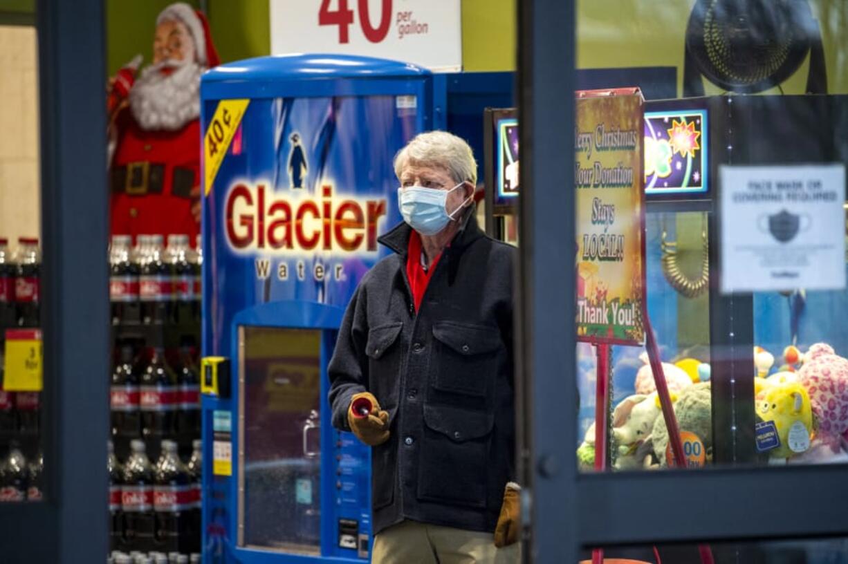 Chuck Mulligan rings a bell and wishes shoppers a Merry Christmas at Fred Meyer&#039;s Grand Central location. Mulligan, who had a shift from 10:30 a.m. to 12:30 p.m. that day, is in his 58th year ringing the bell at the Salvation Army kettle.