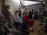 Veterans Lawrence Doyle, from left, John Stephens and James Curry receive a round of applause after getting their COVID-19 vaccinations at the Community Living Center on the Veterans Affairs campus Thursday morning.