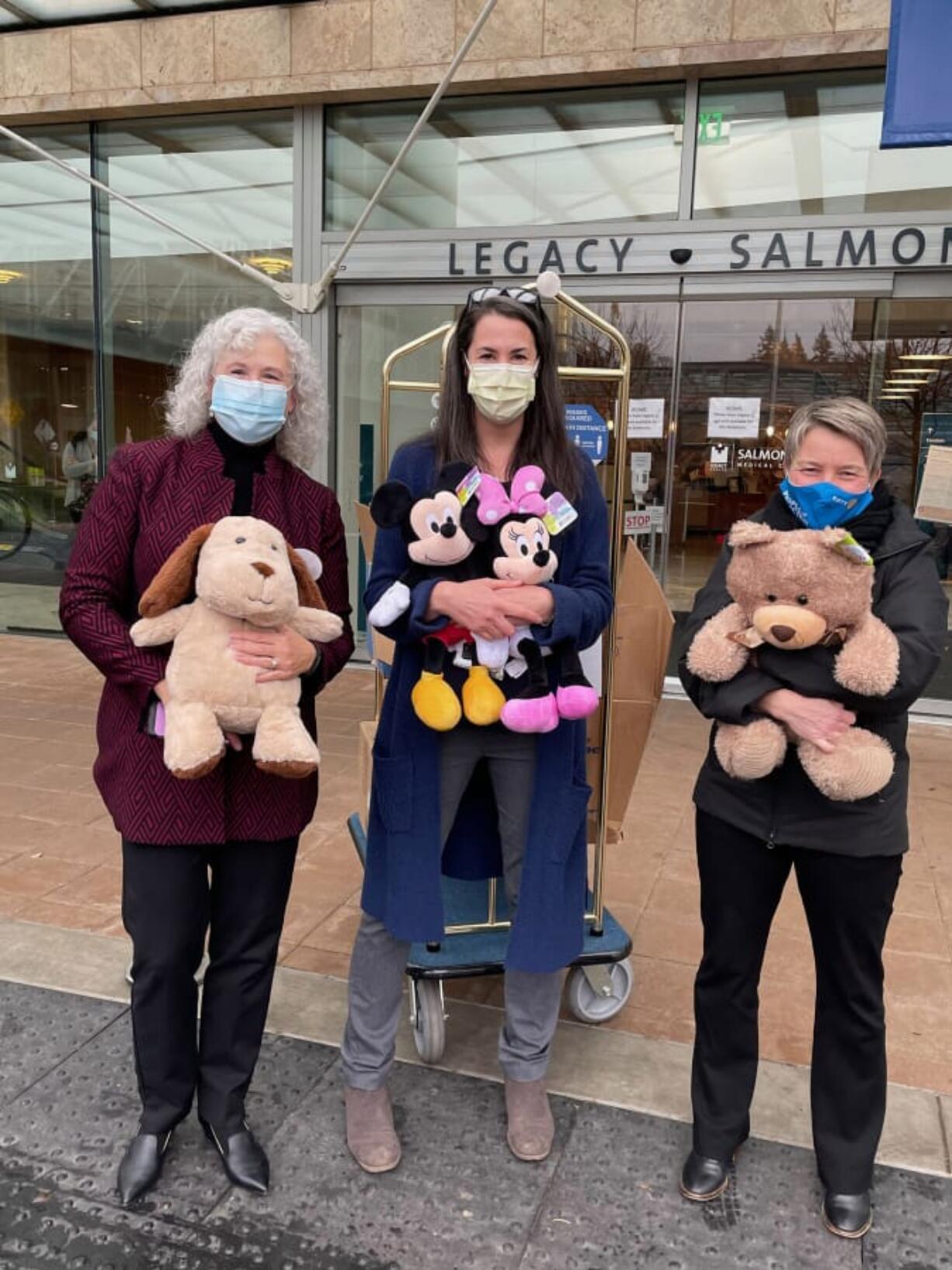 SALMON CREEK: Shirley Gross, left, and Dana Hughes, center, of Legacy Salmon Creek, and Susanne Holmberg, of Rotary Club of Three Creeks, unload new stuffed animals for children at Legacy Salmon Creek Medical Center.