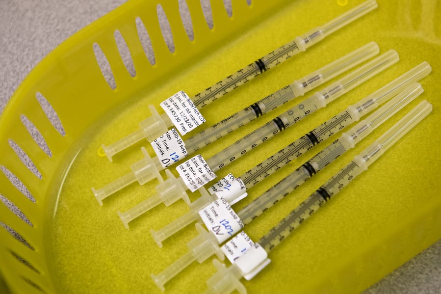 Syringes containing the COVID-19 vaccine are pictured at PeaceHealth Urgent Care Memorial.