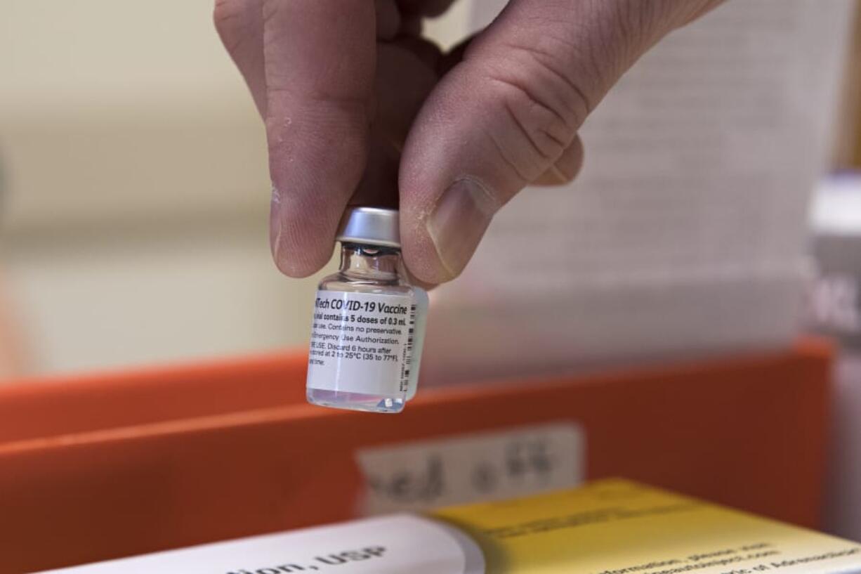 A vial with the COVID-19 vaccine is pictured at PeaceHealth Urgent Care Memorial on Tuesday morning.