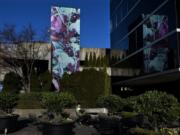 Joseph Bailey of Vancouver takes a seat near the new &quot;Bramble&quot; mural by artist Jane Degenhardt in downtown Vancouver on Monday. The new 30-foot mural is one of the first public art pieces to come to fruition under Vancouver&#039;s new Arts, Culture and Heritage Commission.