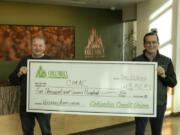 VANCOUVER: Columbia Credit Union President and CEO Steve Kenny, left, presents Community Military Appreciation Committee Board Member Bruce Evans with a check.