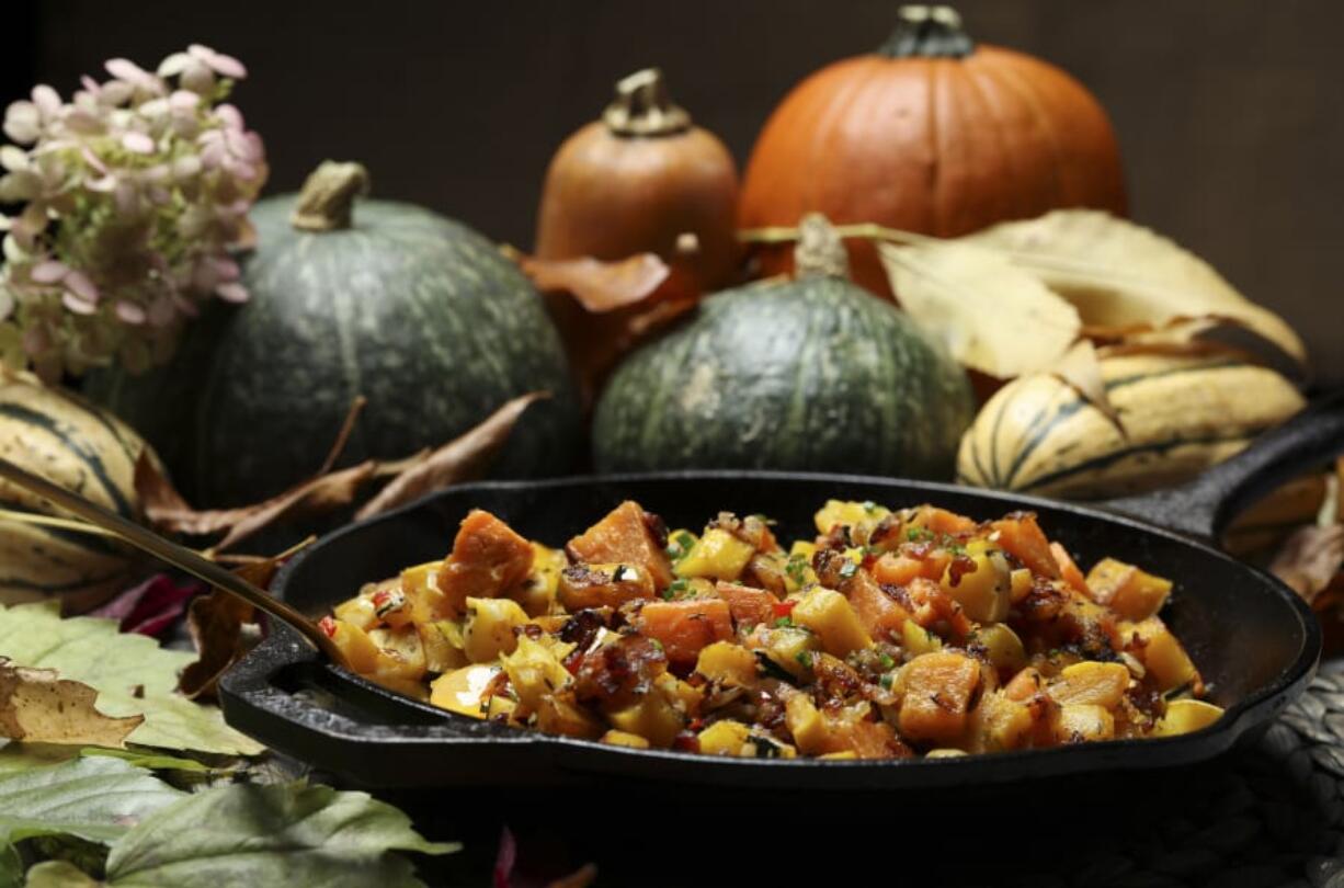 The squash and sweet potato hash makes a fabulous side dish for Thanksgiving dinner. Or, serve it topped with a fried egg and slices of smoky ham for a weekend brunch.