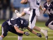 Rogers Rams QB Tyler Van Sligtenhorst, #2, leaps over Skyview LB Jason Leineweber, #40, at Kiggins Bowl, Saturday, November 15, 2008.