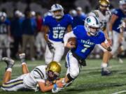 A Kelso defender brings down Mountain View quarterback Riley McCarthy during a game at McKenzie Stadium on Friday night, Oct. 25, 2019.