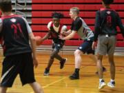 Fort Vancouver&#039;s Kahlil Singleton, center, at a practice back in January, found other teams to play with in other states during Washington&#039;s pandemic shut down of high school sports.