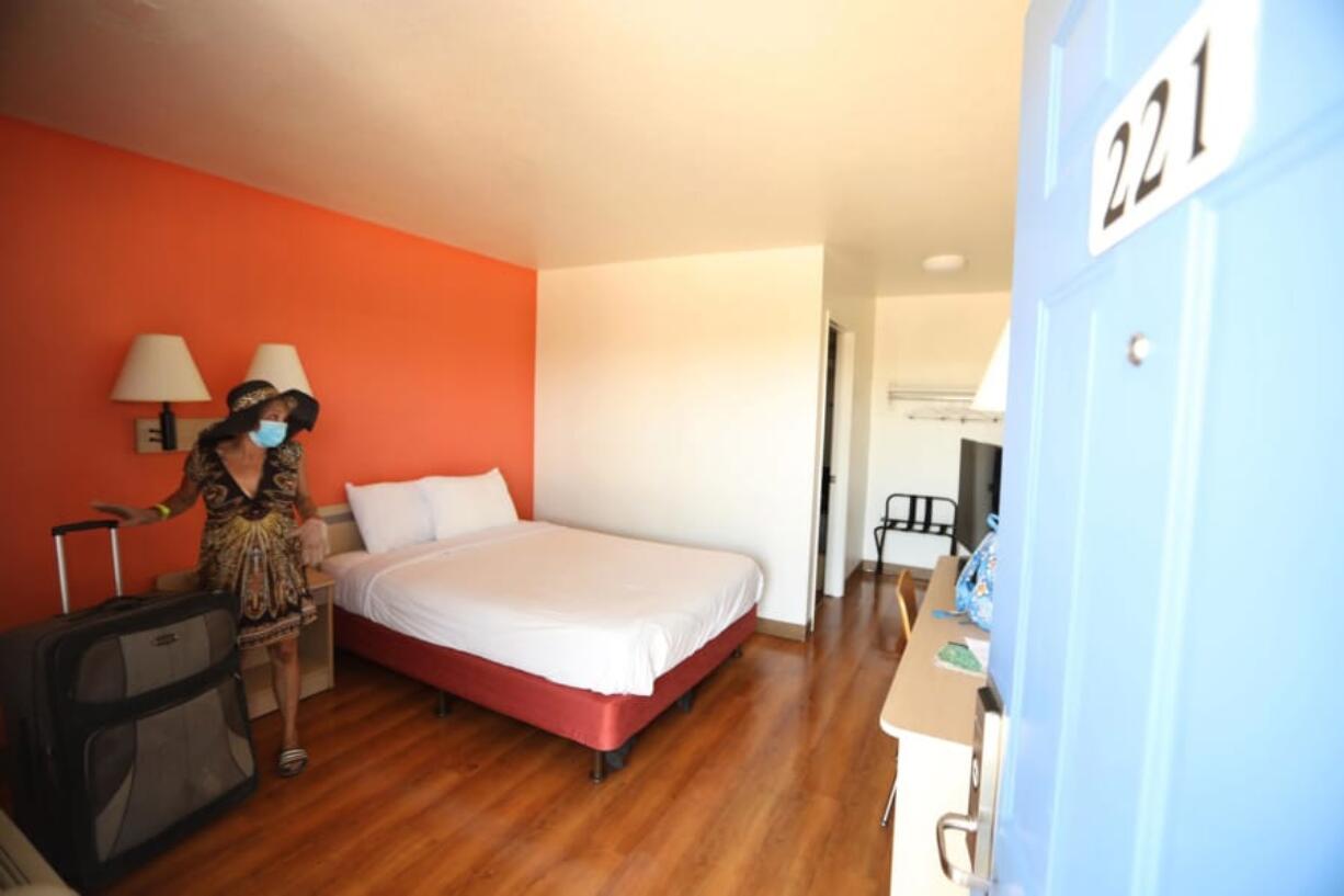 Genia Hope, 52, moves into her new room at a hotel that is being used for Project Roomkey in Whittier, Calif., on July 7.  Oregon&#039;s Project Turnkey, modeled after a similar program in California, was born out of the need to provide shelter and practice social distancing during the pandemic. The economic effects of the pandemic and wildfires have compounded a preexisting homelessness and affordable housing crisis on the West Coast.