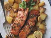 Salmon marinated in a spicy-sweet mix of brown sugar, soy sauce, ginger and chili is roasted along with potatoes for a quick and healthy dinner.