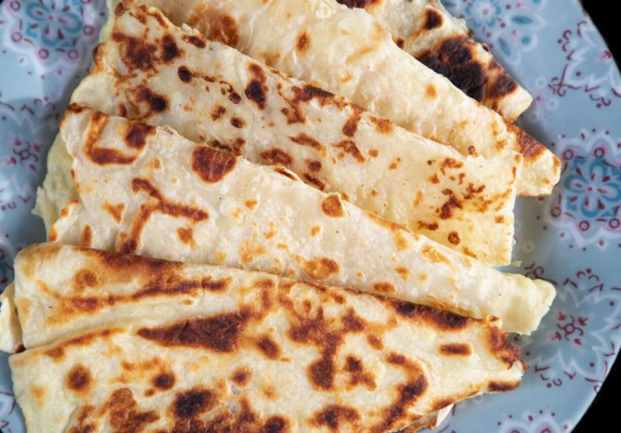 Charles Schrag of Seattle has been making the traditional Norwegian food lefse since he was young. Schrag shows off his lefse, which is similar to a flatbread, made with potatoes near his Seattle-area home Dec. 7, 2020.