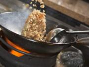 Cook Crabmeat Fried Rice in a flat-bottomed wok pan.