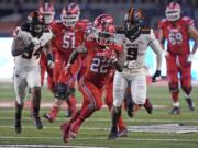 Utah running back Ty Jordan (22) carries the ball during the first half of the team's NCAA college football game against Oregon State on Saturday, Dec. 5, 2020, in Salt Lake City.