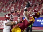 Southern California wide receiver Amon-Ra St. Brown, right, catches a touchdown over Washington State defensive back Armani Marsh during the first half of an NCAA college football game in Los Angeles, Sunday, Dec. 6, 2020.