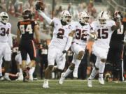 Stanford's Curtis Robinson (2), Jonathan McGill (32) and Stephen Herron (15) celebrate Robinson's recovery of an Oregon State fumble during the last minute of the second half in an NCAA college football game in Corvallis, Ore., Saturday, Dec. 12, 2020. Stanford won 27-24.