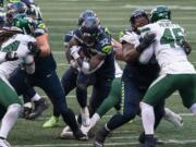 Seattle Seahawks running back Chris Carson runs the ball during the second half of an NFL football game against the New York Jets, Sunday, Dec. 13, 2020, in Seattle. The Seahawks won 40-3.