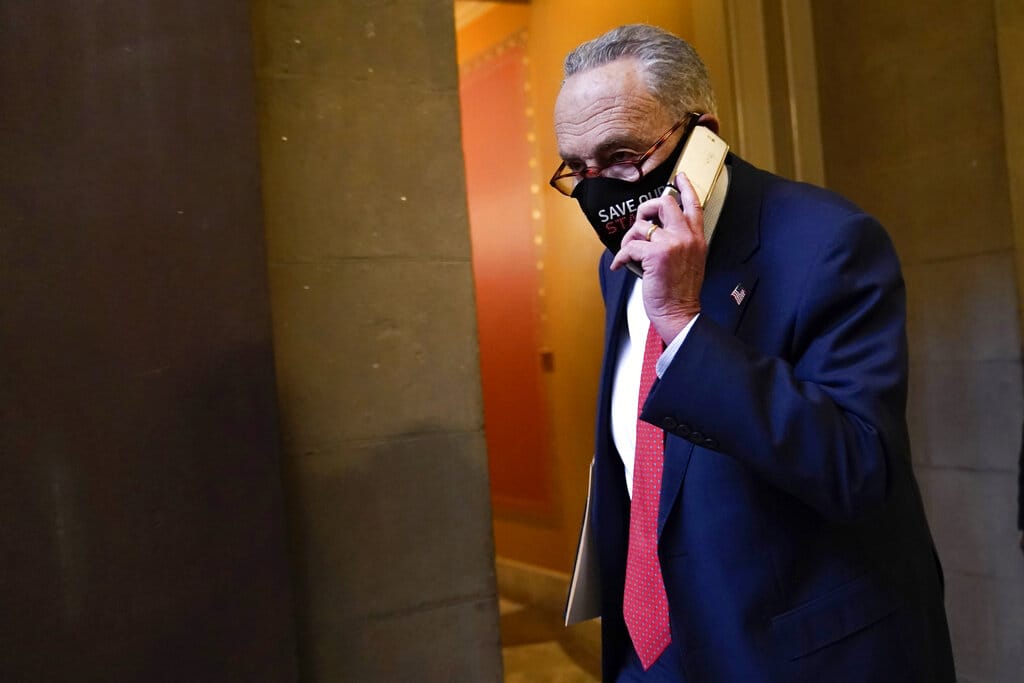 Senate Minority Leader Sen. Chuck Schumer of N.Y., walks on Capitol Hill in Washington, Tuesday, Dec. 15, 2020.