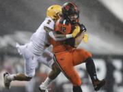 Oregon State inside linebacker Jack Colletto (12), a Camas High grad, is brought down by Arizona State defensive back DeAndre Pierce (2) during the first half of an NCAA college football game in Corvallis, Ore., Saturday, Dec. 19, 2020.