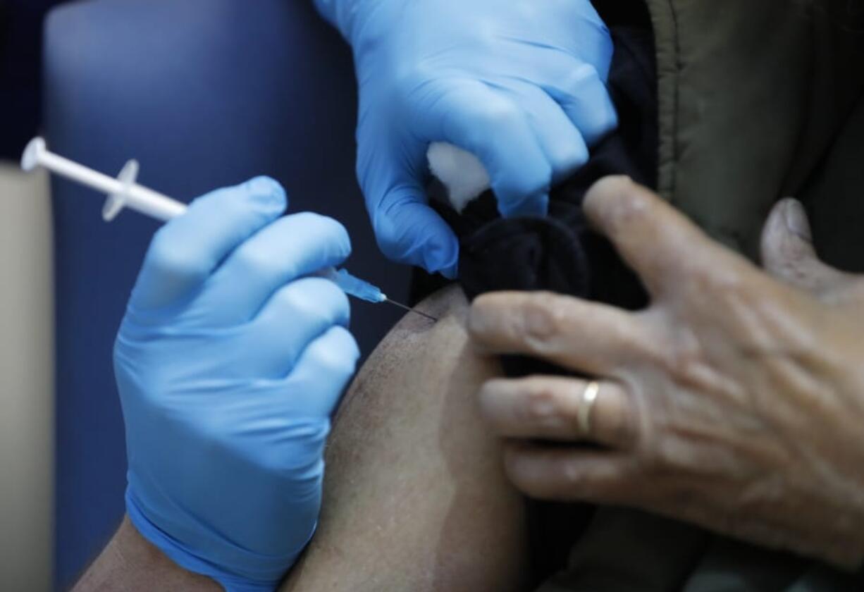 A nurse administers the Pfizer-BioNTech COVID-19 vaccine at Guy&#039;s Hospital in London, Tuesday, Dec. 8, 2020. U.K. health authorities rolled out the first doses of a widely tested and independently reviewed COVID-19 vaccine Tuesday, starting a global immunization program that is expected to gain momentum as more serums win approval.