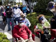 Joel and Susan Pittelman, from Naples, Fla., wait in line to receive COVID-19 vaccines on Tuesday, Dec. 29, 2020, at East County Regional Library in Lehigh Acres, Fla.