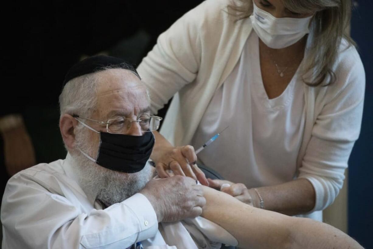 Rabbi Yisrael Meir Lau receives a COVID-19 coronavirus vaccine at the Ichilov Hospital in Tel Aviv, Israel, Sunday, Dec. 20, 2020.