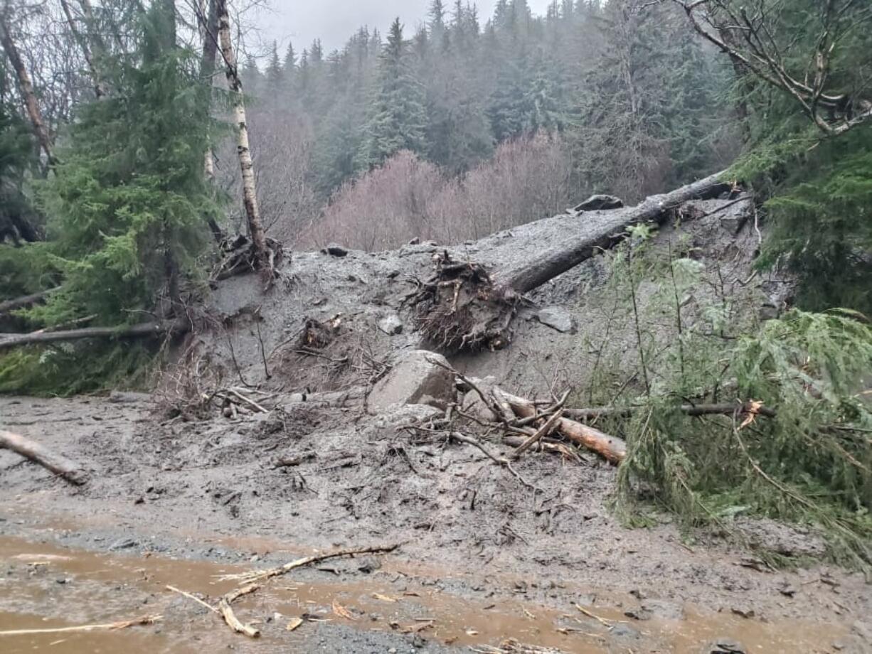 This photo provided by the Alaska Department of Transportation and Public Facilities shows damage from heavy rains and a mudslide 600 feet wide in Haines, Alaska, on Wednesday, Dec. 2, 2020. Authorities say six people are unaccounted for, and four homes were destroyed in the slide, with the search resuming Thursday morning for survivors.