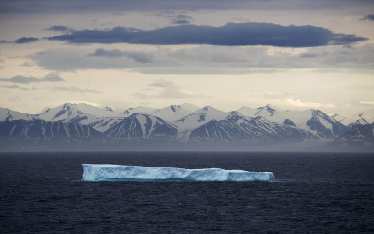 FILE - In this July 24, 2017 file photo, an iceberg floats past Bylot Island in the Canadian Arctic Archipelago. The National Oceanic and Atmospheric Administration&#039;s annual Arctic Report Card, released on Tuesday, Dec. 8, 2020, shows how warming temperatures in the Arctic are transforming the region&#039;s geography and ecosystems.