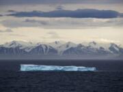 FILE - In this July 24, 2017 file photo, an iceberg floats past Bylot Island in the Canadian Arctic Archipelago. The National Oceanic and Atmospheric Administration&#039;s annual Arctic Report Card, released on Tuesday, Dec. 8, 2020, shows how warming temperatures in the Arctic are transforming the region&#039;s geography and ecosystems.