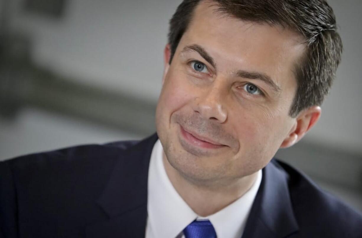 FILE - In this April 29, 2019 file photo, then Democratic presidential candidate Mayor Pete Buttigieg, from South Bend, Indiana, listens during a lunch meeting with civil rights leader Rev. Al Sharpton at Sylvia&#039;s Restaurant in Harlem neighborhood of New York. President-elect Joe Biden is expected to pick former South Bend, Indiana, mayor Pete Buttigieg to head the transportation department.