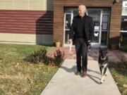 FILE - This Nov. 16, 2018, photo, file provided by the Delaware Humane Association shows Joe Biden and his newly-adopted German shepherd Major, in Wilmington, Del. President-elect Biden will likely wear a walking boot for the next several weeks as he recovers from breaking his right foot while playing with his dog Major on Saturday, Nov. 28, 2020, his doctor said.