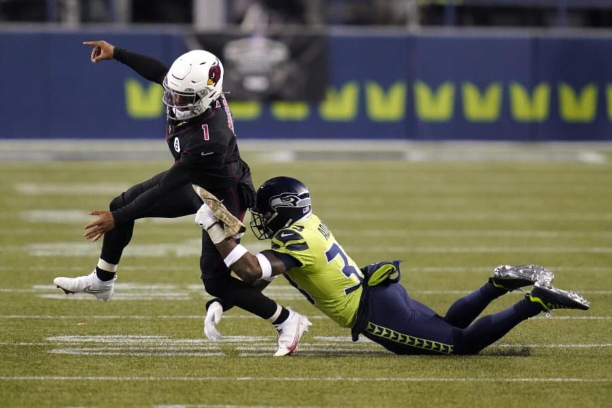 Seattle Seahawks strong safety Jamal Adams, right, gets to Arizona Cardinals quarterback Kyler Murray (1) just as Murray gets a pass off, during the second half of an NFL football game, Thursday, Nov. 19, 2020, in Seattle.