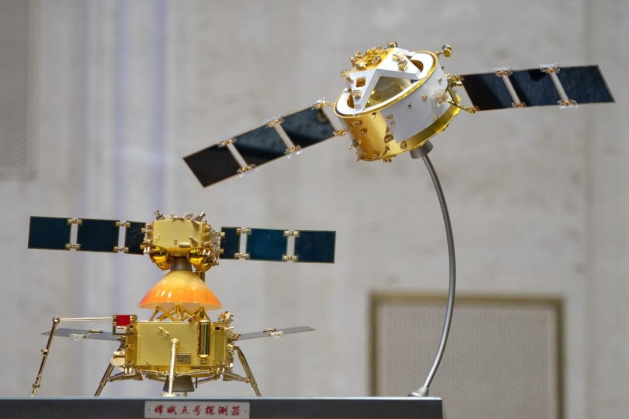 A model of China&#039;s Chang&#039;e 5 lunar orbiter and lander are displayed before a press conference at the State Council Information Office in Beijing, Thursday, Dec. 17, 2020. Following the successful return of moon rocks by its Chang&#039;e 5 robotic probe, China is preparing for future missions that could set the stage for an eventual lunar base to host human explorers.