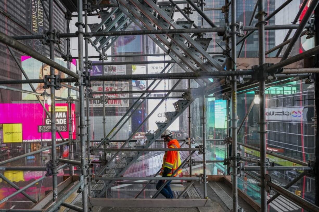 A construction worker walks down a staircase in the scaffolding of TSX Broadway under construction, Thursday, Oct. 29, 2020, in New York&#039;s, Times Square. The 46-story mixed-use property will house 75,000 square feet of retail space, a 4,000-square-foot performance venue including an outdoor stage, an outdoor food and beverage terrace and a luxury hotel. U.S. construction spending rose 0.3% in September, the fourth straight monthly gain after a coronavirus-caused spring swoon.