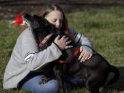 Debra Mejeur hugs her dog Lola on Dec. 5 outside DuPage County Animal Services, in Wheaton, Ill., as they reunite three years after Lola went missing during a trip to suburban Chicago.