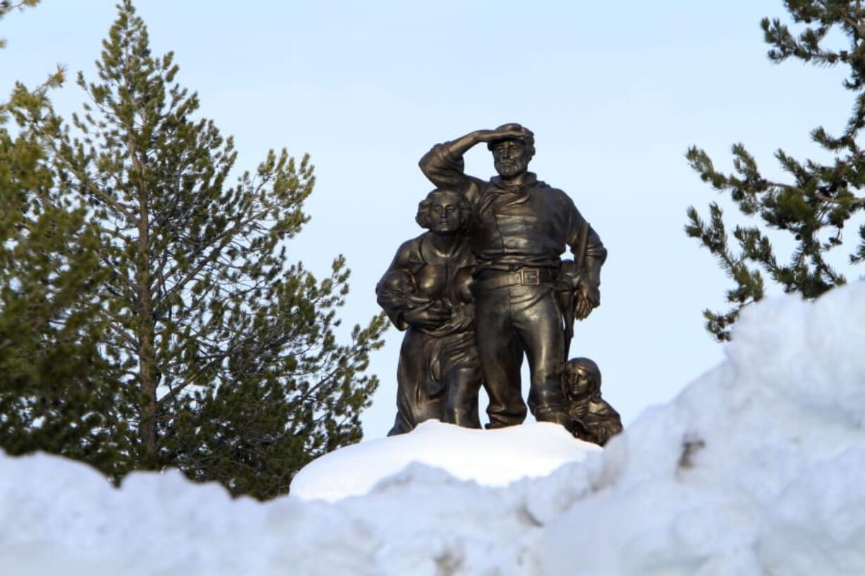 FILE - In this file photo taken Monday, March 28, 2011, the Pioneer Memorial, dedicated to the Donner Party, is seen behind snow cleared from the parking lot at the Donner Memorial State Park at Truckee, Calif. A pair of backcountry endurance athletes who became obsessed with the Donner Party spent the last seven years researching and exploring the Sierra on foot to try to pinpoint the final 90-mile route the only survivors of the tragic tale of cannibalism, murder, and mayhem finally cut through mountain snowdrifts to safety in the winter of 1846-47. Now, four veteran ultrarunners from Northern California are setting out on snowshoes to retrace the footsteps of the pioneers who braved the worst blizzard in a century to escape the horrors over the top of what&#039;s now called Donner Pass through the Emigrant Gap.