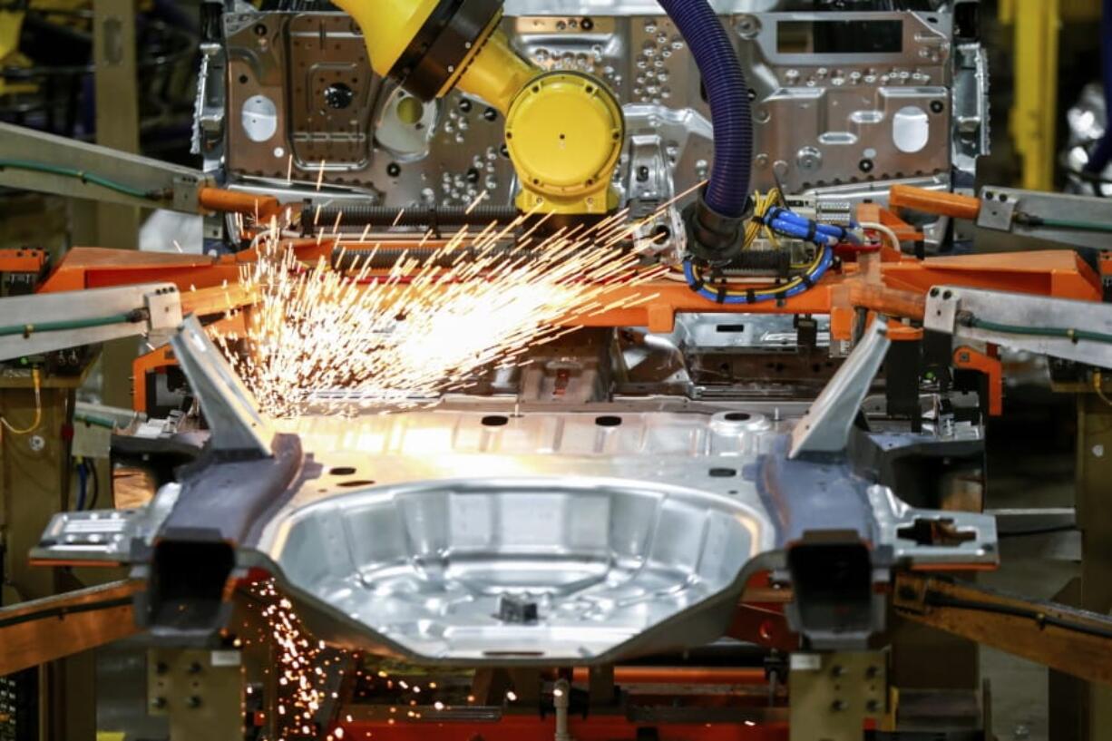 FILE - In this June 24, 2019, file photo machines work on a Ford vehicle assembly line at Ford&#039;s Chicago Assembly Plant in Chicago.  American factories expanded at a faster pace last month, continuing a rebound from the coronavirus recession. The Institute for Supply Management, an association of purchasing managers, reported Tuesday, Sept. 1, 2020,  that its manufacturing index climbed to 56 in August from 54.2 in July.