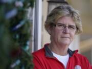 Keli Paaske stands outside her home in Olathe, Kan. Friday, Dec. 4, 2020. Paaske was laid off in August from a company supplying fire doors to hospitals after being furloughed for five months and has struggled to find a new job.