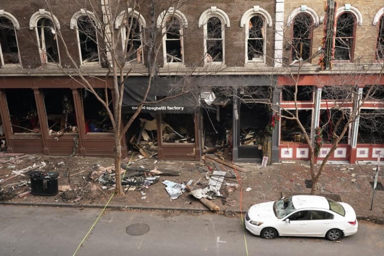 FILE - In this Dec. 29, 2020 file photo, debris remains on the sidewalk in front of buildings damaged in a Christmas Day explosion  in Nashville, Tenn.   The Christmas Day bombing in downtown Nashville led to communications outages over hundreds of miles in the southern U.S., raising concerns about the vulnerability of U.S. networks. Widespread service outages followed the explosion, which damaged a major AT&amp;T network hub, extended hundreds of miles to at least four neighboring states, disrupting 911 call centers, hospitals and flights out of the Nashville airport.