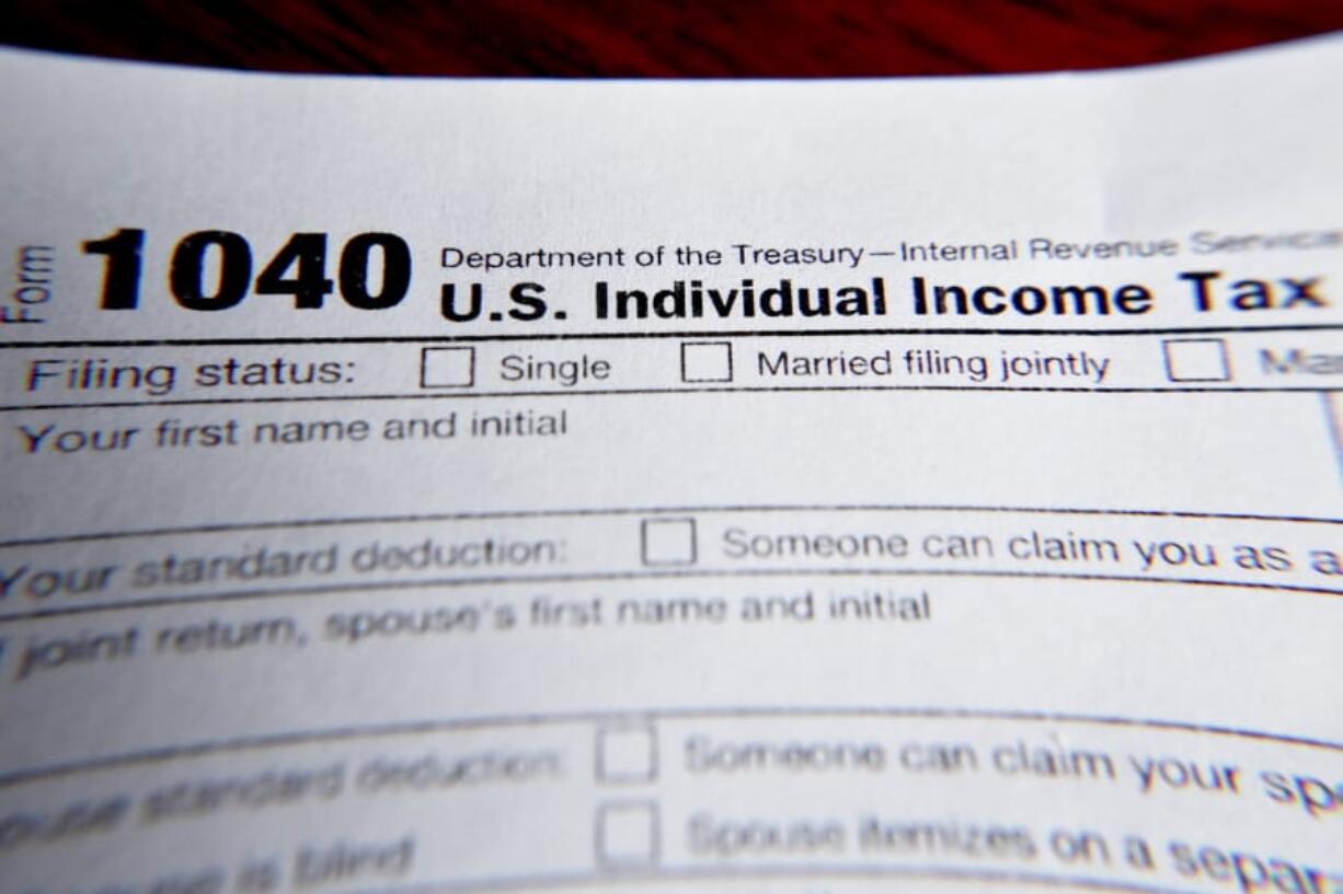 FILE - This Wednesday, Feb. 13, 2019 file photo shows part of a 1040 federal tax form printed from the Internal Revenue Service website, in Zelienople, Pa. Health insurance shoppers who used tax credits to buy coverage in 2020 still have a few weeks left to ward off an unpleasant tax surprise next spring.