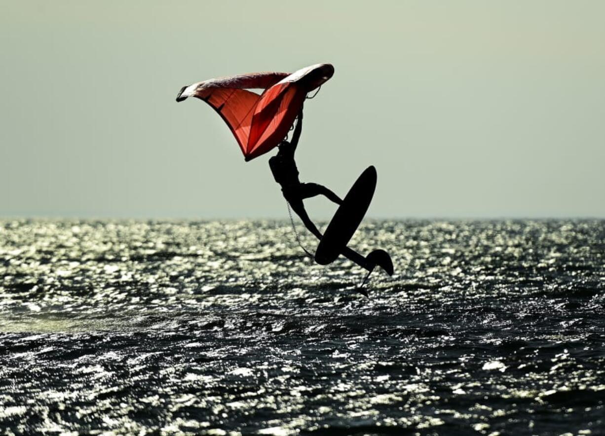 A wing-surfer catches some air on lake Ontario at Cherry Beach on a warm fall day during the COVID-19 pandemic in Toronto on Friday, Nov. 20, 2020. Meteorologists say it&#039;ll be close but it&#039;s looking like 2020 globally will end up as the hottest year on record. The National Oceanic and Atmospheric Administration said Monday, Dec. 14, 2020 that last month was the second hottest November and the first 11 months of the year are the second warmest on record.