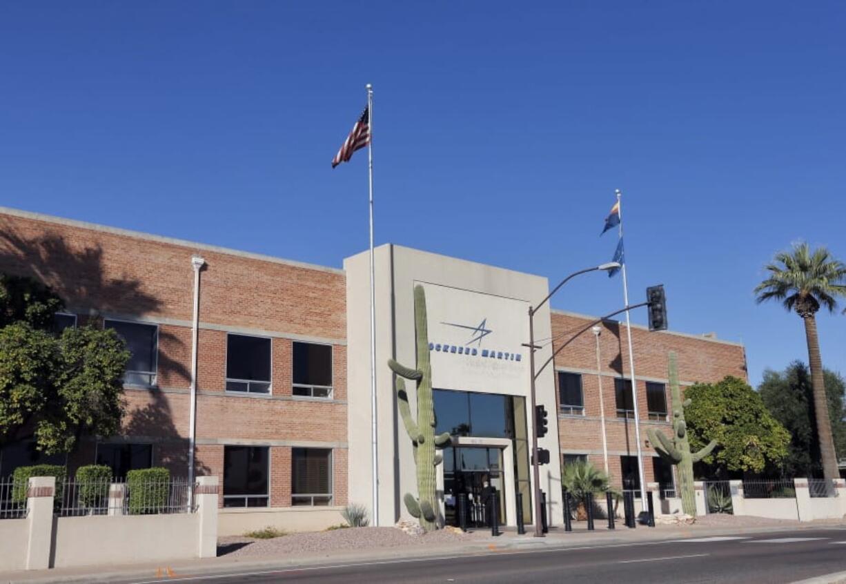 FILE - This Thursday, Nov. 14, 2013, file photo, shows the main entrance of the Lockheed Martin plant in Goodyear, Ariz. In a deal announced Sunday, Dec. 20, 2020, Lockheed Martin is buying rocket engine manufacturer Aerojet Rocketdyne Holdings for $4.4 billion in a deal that brings together companies that already had been working together in the aeronautics industry.