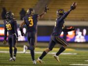 California linebacker Muelu Iosefa, right, celebrates with Josh Drayden (20) and Elijah Hicks (3) after recovering a fumble by Oregon wide receiver Johnny Johnson III during the second half of an NCAA college football game in Berkeley, Calif., Saturday, Dec. 5, 2020.