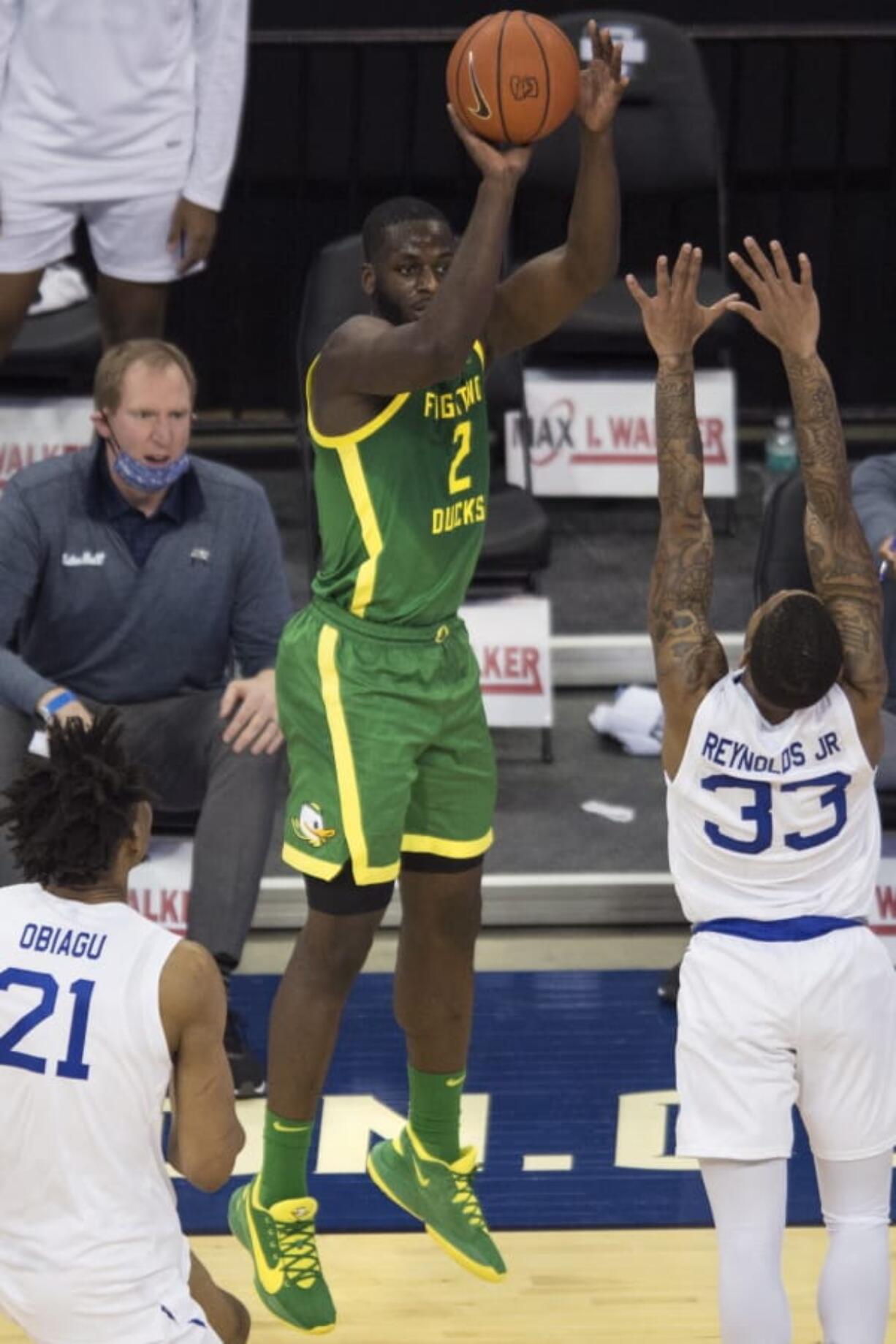 Oregon&#039;s Eugene Omoruyi scores against Seton Hall&#039;s Ike Obiagu, left, and Shavar Reynolds Jr. during the first half of an NCAA college basketball game in Omaha, Neb., Friday, Dec. 4, 2020.