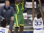 Oregon&#039;s Eugene Omoruyi scores against Seton Hall&#039;s Ike Obiagu, left, and Shavar Reynolds Jr. during the first half of an NCAA college basketball game in Omaha, Neb., Friday, Dec. 4, 2020.