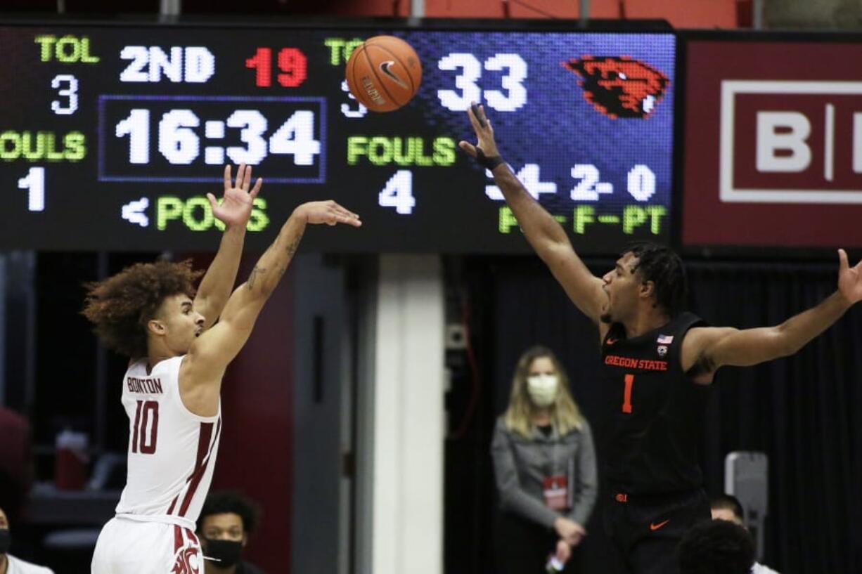 Washington State guard Isaac Bonton (10) shoots over Oregon State forward Maurice Calloo (1) during the second half of an NCAA college basketball game in Pullman, Wash., Wednesday, Dec. 2, 2020. Washington State won 59-55.