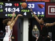 Washington State guard Isaac Bonton (10) shoots over Oregon State forward Maurice Calloo (1) during the second half of an NCAA college basketball game in Pullman, Wash., Wednesday, Dec. 2, 2020. Washington State won 59-55.