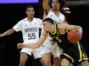 Oregon&#039;s Chris Duarte (5) tries to get past Washington&#039;s Quade Green (55) and Nate Pryor during the first half of an NCAA college basketball game Saturday, Dec. 12, 2020, in Seattle.